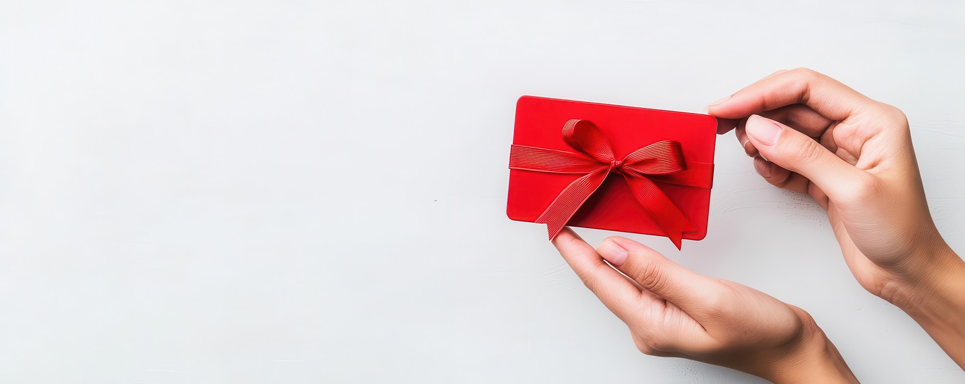 hands presenting a red MaJi gift card